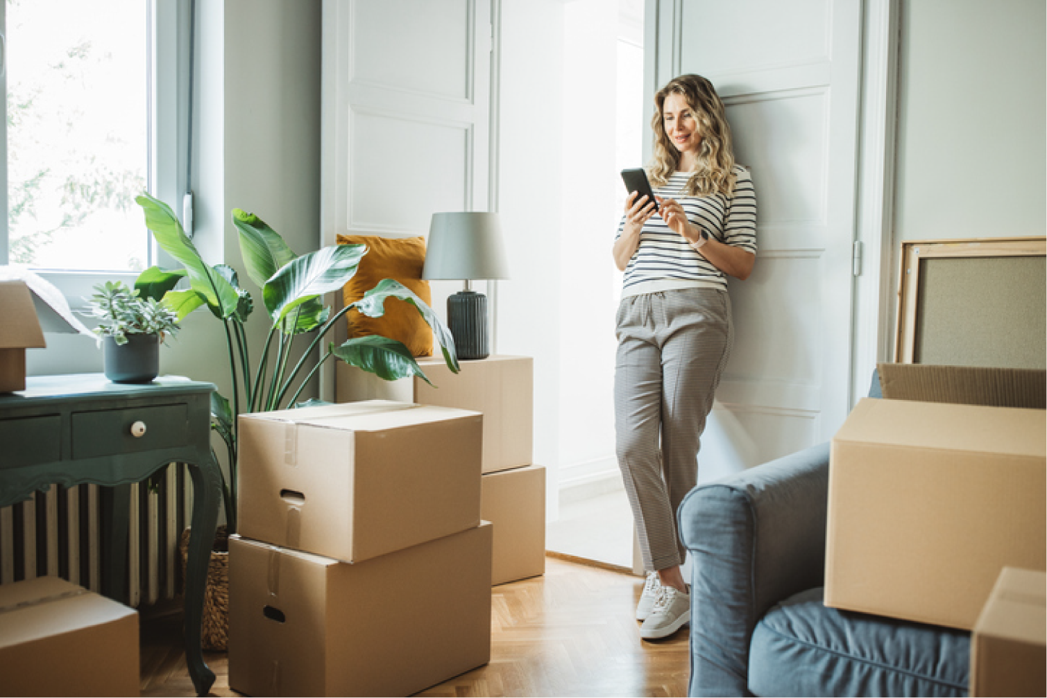New apartment tenant on the phone with moving boxes
