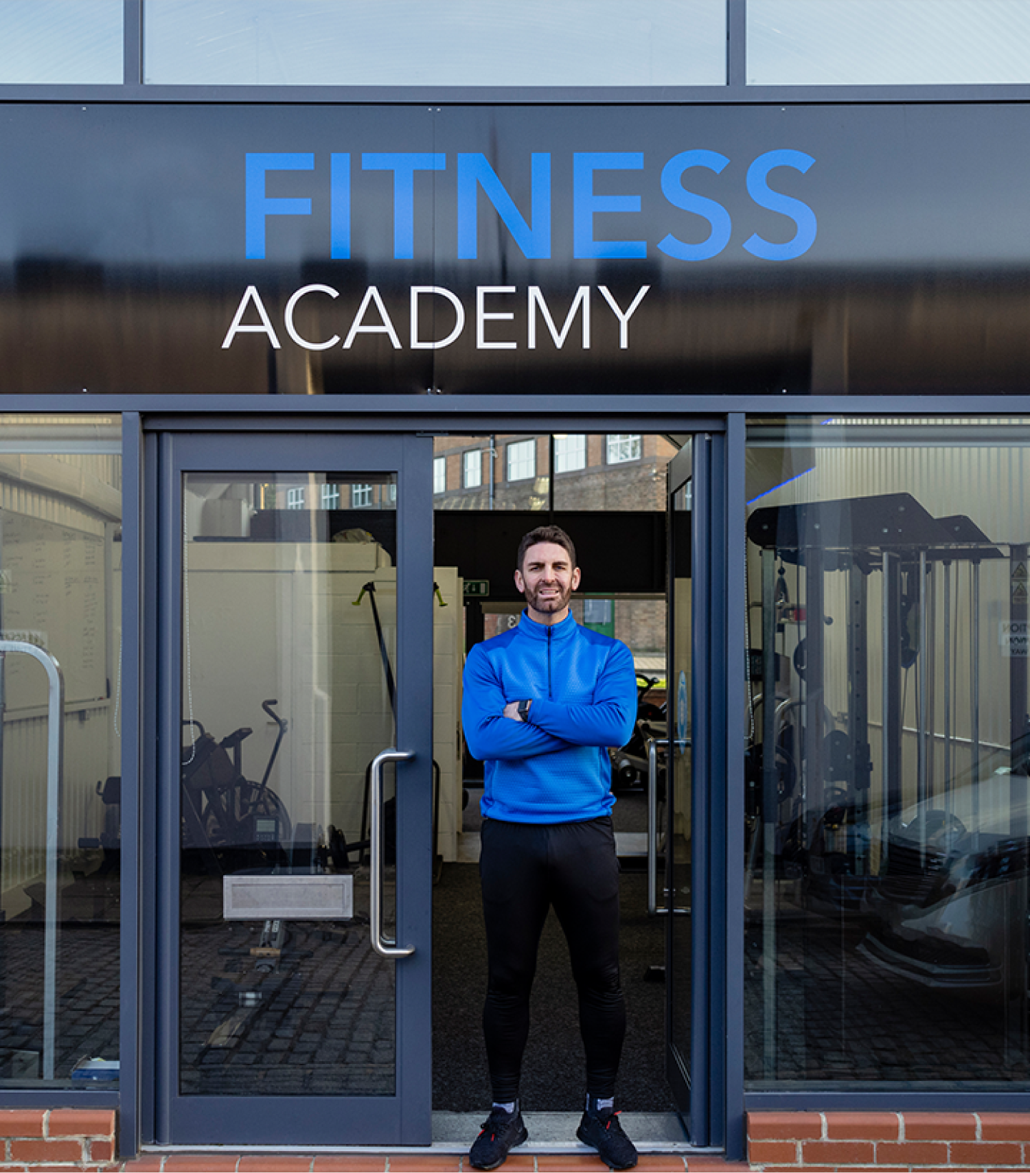 Fitness club staff member speaking with a gym member