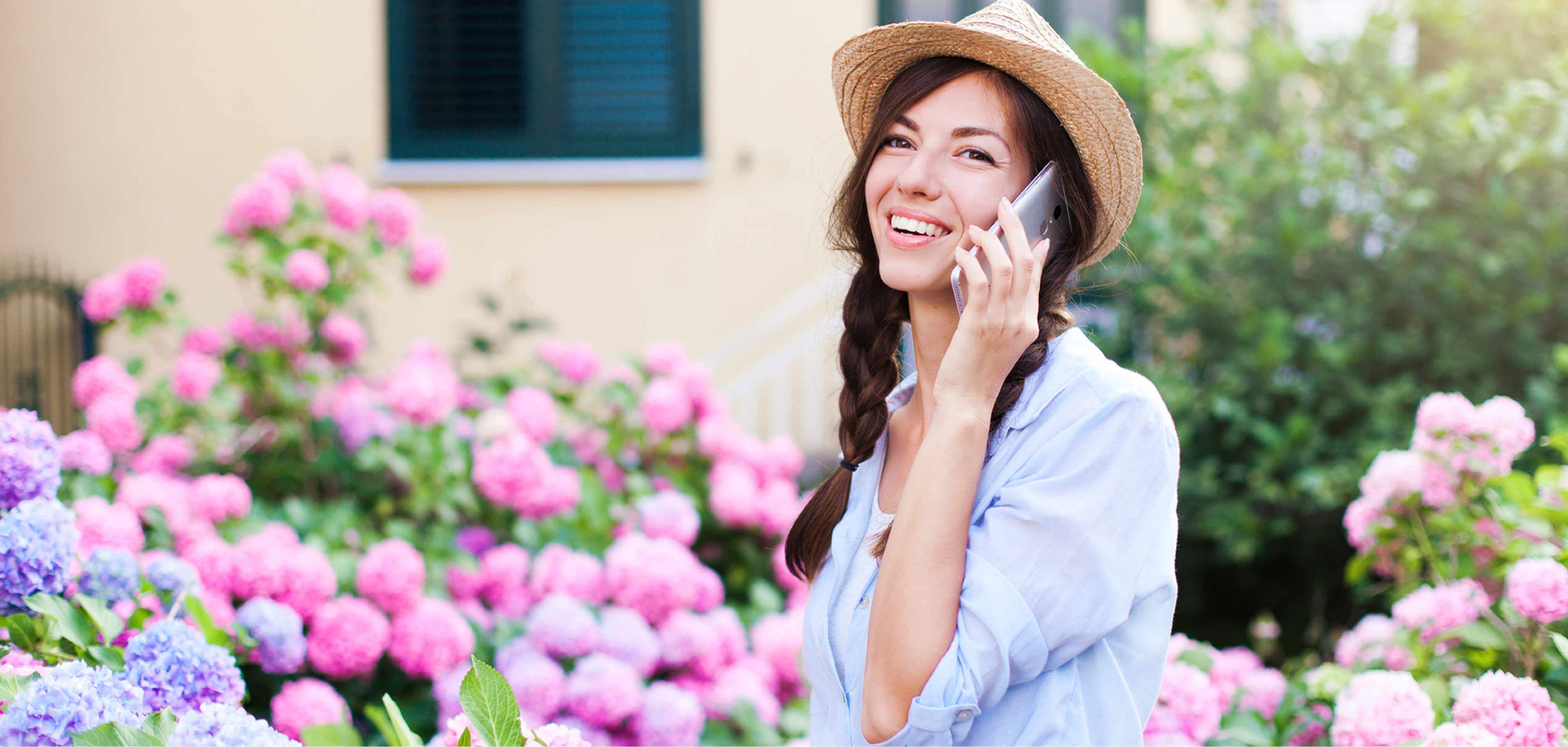 Customer talking on her phone surrounded by flowers at a garden center